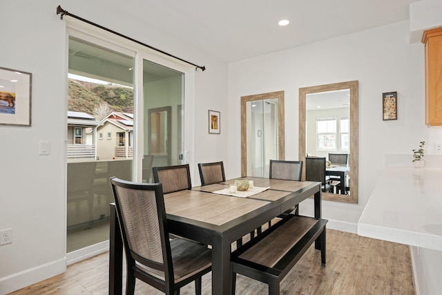 dining area with recessed lighting, light wood-type flooring, and baseboards