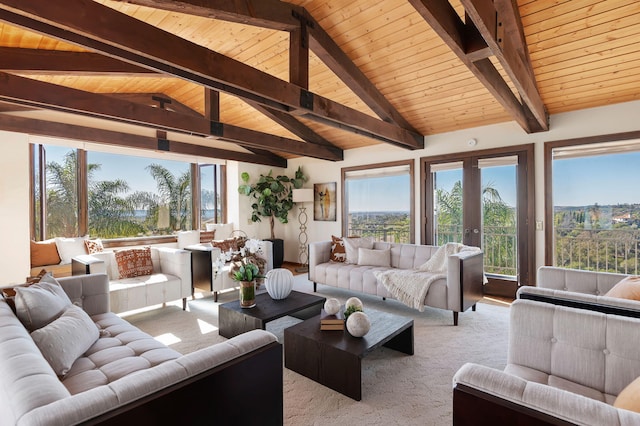 carpeted living area with lofted ceiling with beams, french doors, and wooden ceiling