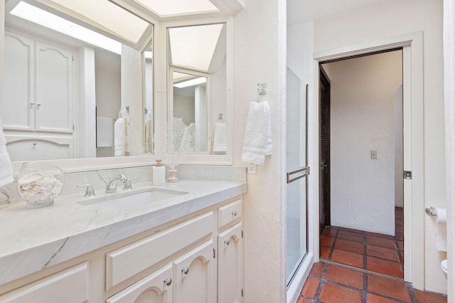 bathroom with tile patterned floors, a stall shower, and vanity