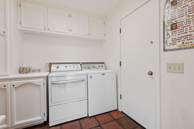 clothes washing area featuring cabinet space and independent washer and dryer