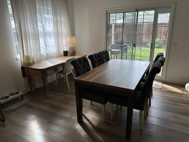 dining space with baseboards and hardwood / wood-style floors