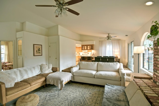 living area with lofted ceiling and a ceiling fan