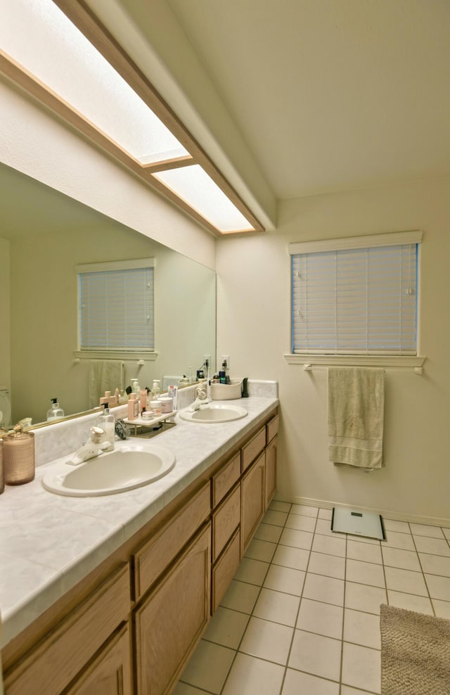 full bathroom featuring tile patterned flooring, double vanity, and a sink