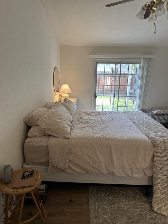 bedroom with wood finished floors, access to exterior, and a ceiling fan