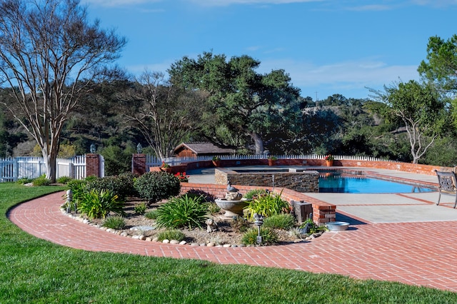 view of pool with a fenced in pool, a lawn, a patio, and fence