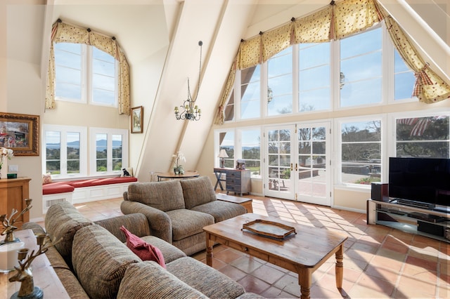 living area featuring french doors, a healthy amount of sunlight, and a towering ceiling