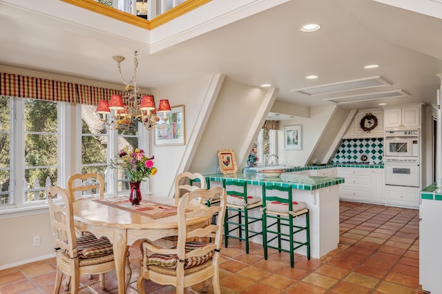 dining room featuring light tile patterned floors, recessed lighting, and a chandelier