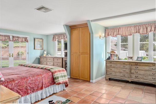 bedroom with access to exterior, visible vents, baseboards, light tile patterned floors, and french doors