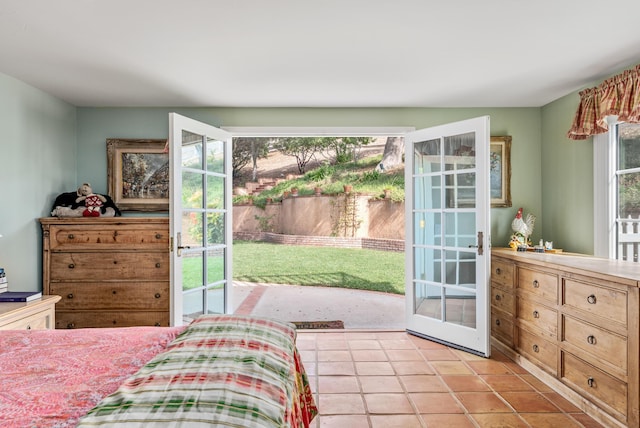 bedroom with multiple windows and light tile patterned flooring