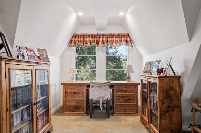 home office with lofted ceiling and light carpet