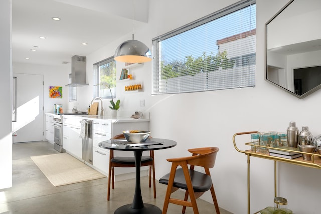 903 W Mission St, Santa Barbara, CA 93101 - kitchen with light countertops, exhaust hood, concrete flooring, stainless steel appliances, and recessed lighting