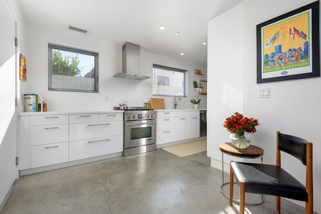 903 W Mission St, Santa Barbara, CA 93101 - kitchen with high end range, modern cabinets, wall chimney range hood, and visible vents