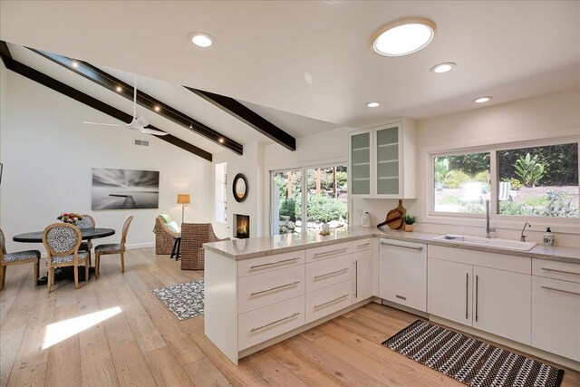 5134 Cathedral Oaks Rd, Santa Barbara, CA 93111 - kitchen with glass insert cabinets, lofted ceiling with beams, a peninsula, white dishwasher, and a sink