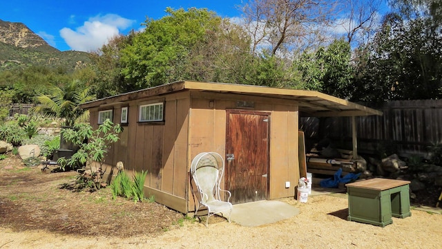 view of shed featuring fence