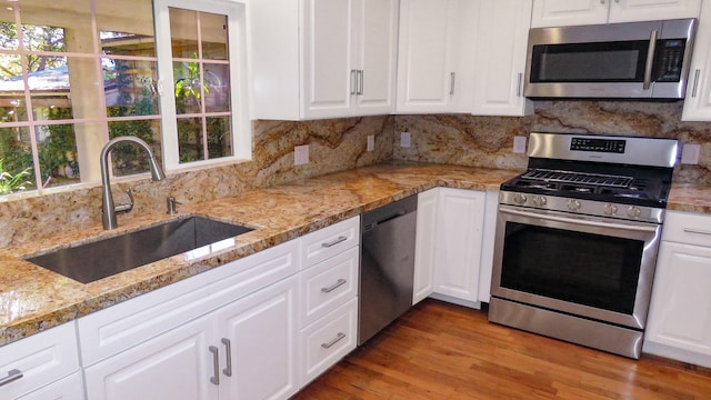 kitchen featuring white cabinetry, a sink, and stainless steel appliances