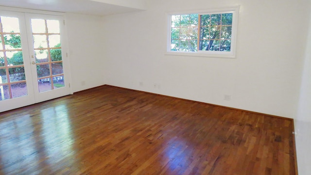 empty room with french doors and wood finished floors