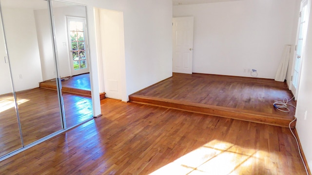 unfurnished bedroom with hardwood / wood-style floors