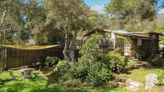 view of yard featuring fence and a deck