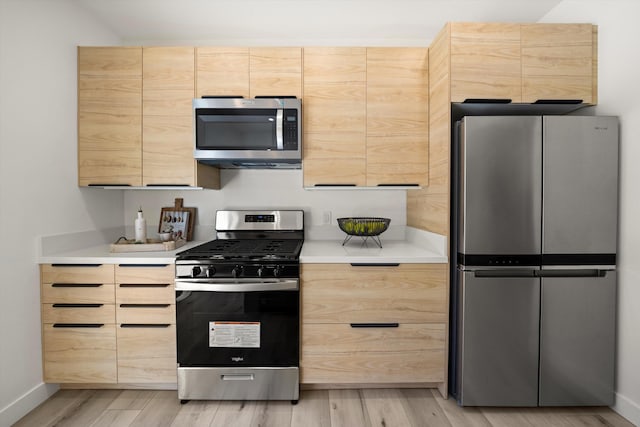 334 W Mission St, Santa Barbara, CA 93101 - kitchen with appliances with stainless steel finishes, light brown cabinetry, light wood-style floors, and light countertops