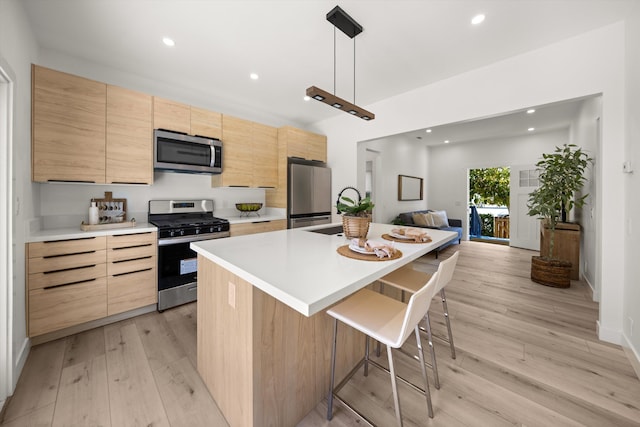 334 W Mission St, Santa Barbara, CA 93101 - kitchen with appliances with stainless steel finishes, modern cabinets, light brown cabinets, a center island with sink, and recessed lighting