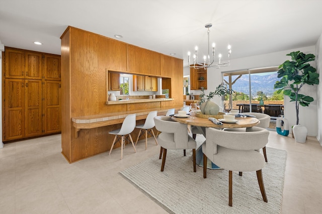 dining area featuring recessed lighting and an inviting chandelier