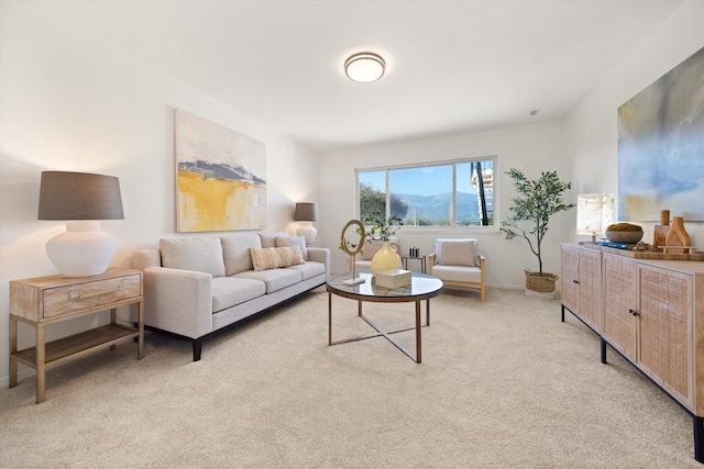 living area featuring baseboards and light carpet