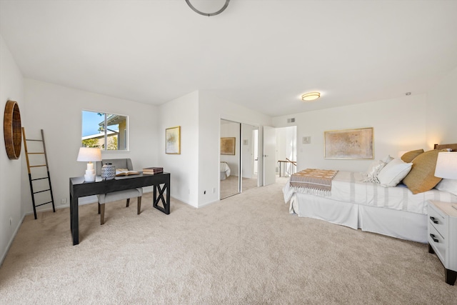 bedroom with visible vents, baseboards, and light carpet