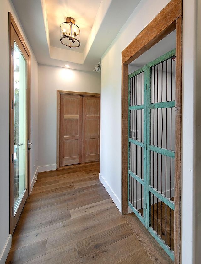 741 Saddle Ln, Ojai, CA 93023 - foyer with baseboards, a chandelier, wood finished floors, and a raised ceiling