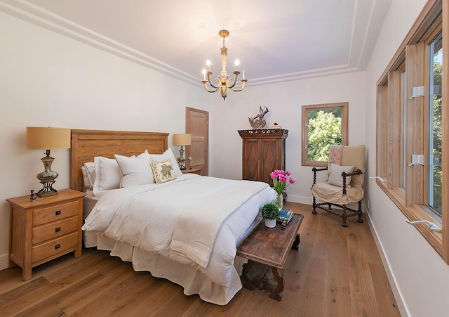 741 Saddle Ln, Ojai, CA 93023 - bedroom featuring a chandelier, baseboards, and wood finished floors