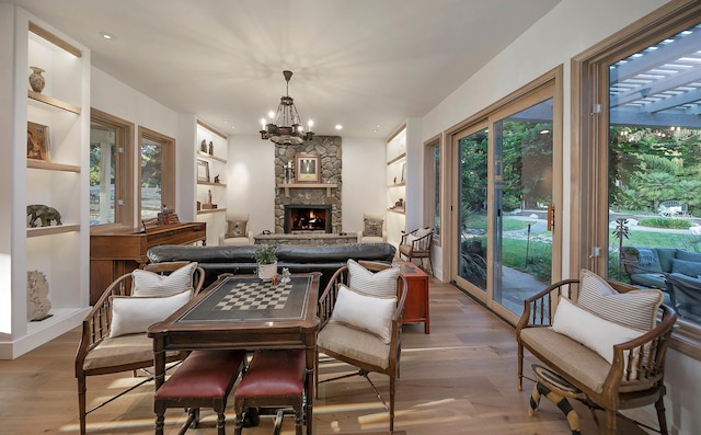 741 Saddle Ln, Ojai, CA 93023 - dining room with wood finished floors, a chandelier, a fireplace, and recessed lighting