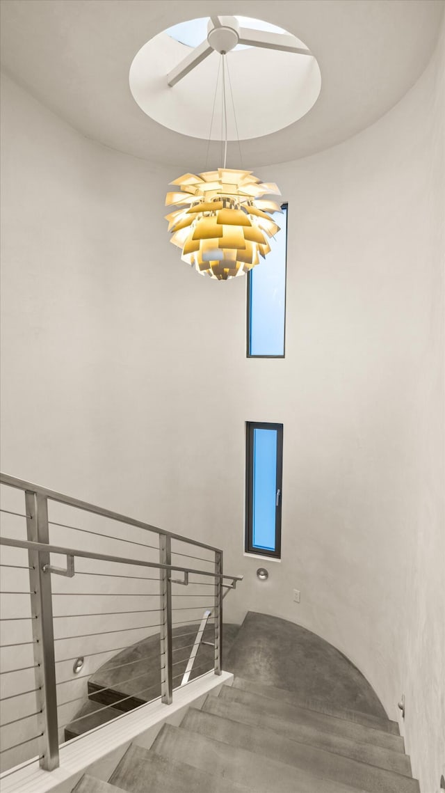 stairs with an inviting chandelier