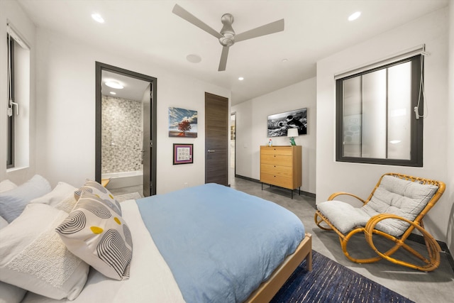 bedroom featuring baseboards, ensuite bathroom, recessed lighting, a ceiling fan, and concrete floors