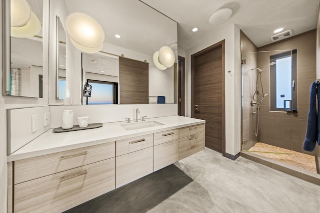 bathroom featuring vanity, recessed lighting, and a stall shower