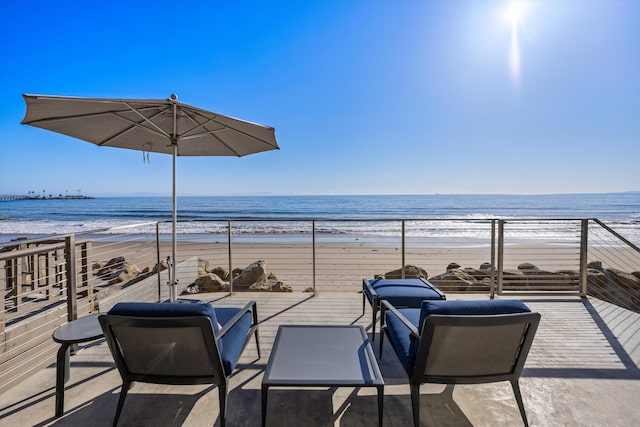 view of patio / terrace featuring a beach view and a water view