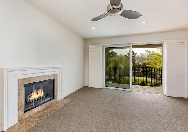 unfurnished living room featuring recessed lighting, a high end fireplace, ceiling fan, and carpet flooring
