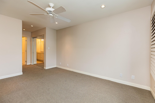 carpeted spare room with recessed lighting, ceiling fan, and baseboards