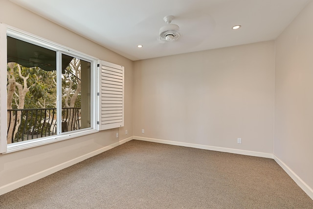 spare room featuring recessed lighting, carpet flooring, and baseboards