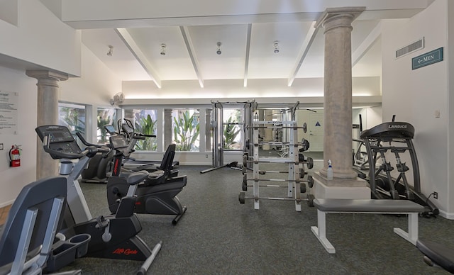 exercise room featuring visible vents and decorative columns