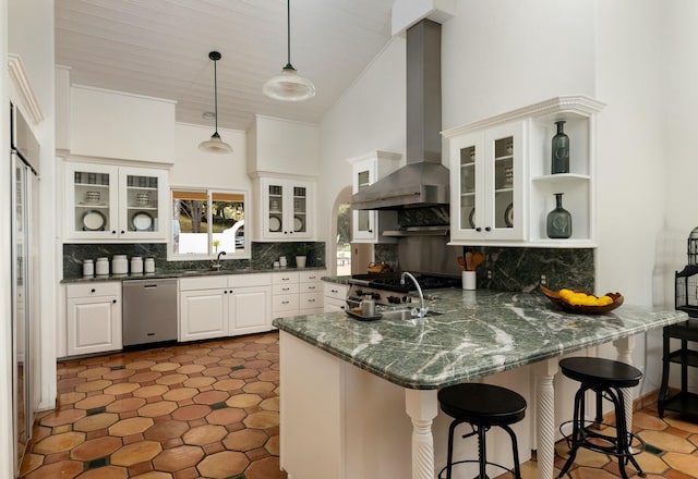 1060 Ladera Ln, Santa Barbara, CA 93108 - kitchen with wall chimney range hood, a peninsula, decorative backsplash, stainless steel dishwasher, and pendant lighting