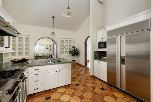 1060 Ladera Ln, Santa Barbara, CA 93108 - kitchen with white cabinets, built in appliances, glass insert cabinets, and wall chimney exhaust hood