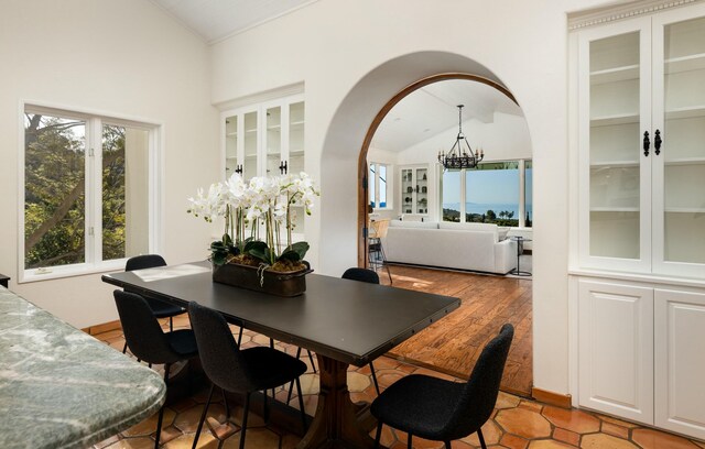 1060 Ladera Ln, Santa Barbara, CA 93108 - dining space featuring light wood-type flooring, arched walkways, a chandelier, and vaulted ceiling