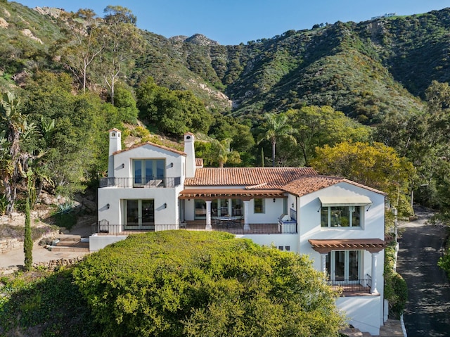 1060 Ladera Ln, Santa Barbara, CA 93108 - back of property with a balcony, stucco siding, a mountain view, a chimney, and a tiled roof
