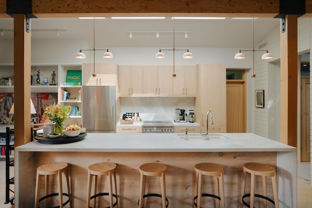 216 E Matilija St, Ojai, CA 93023 - kitchen featuring a breakfast bar, range, freestanding refrigerator, pendant lighting, and a sink