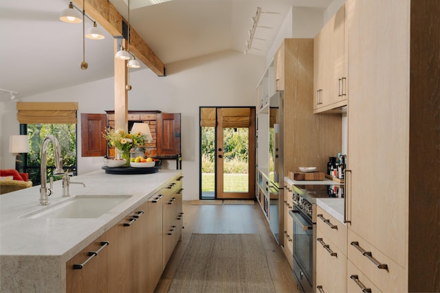 216 E Matilija St, Ojai, CA 93023 - kitchen featuring a sink, light stone countertops, lofted ceiling with beams, and light brown cabinets