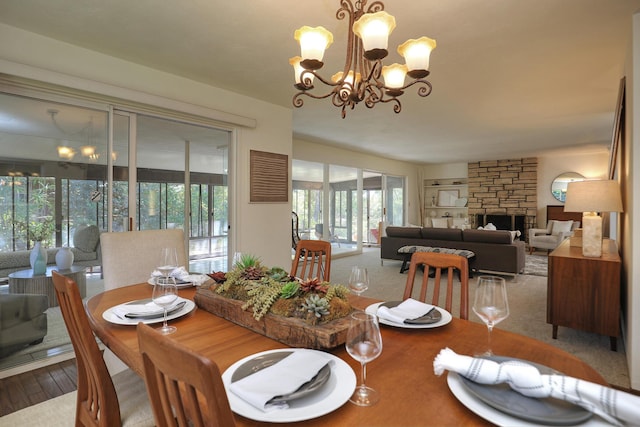 840 Mission Canyon Rd, Santa Barbara, CA 93105 - dining area with a chandelier, a stone fireplace, and wood finished floors