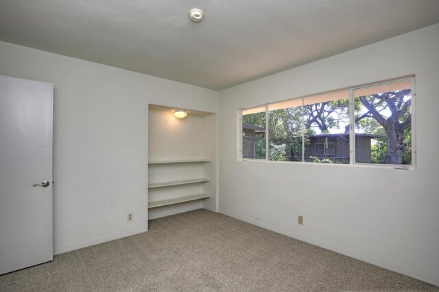 840 Mission Canyon Rd, Santa Barbara, CA 93105 - carpeted empty room featuring plenty of natural light and a textured ceiling