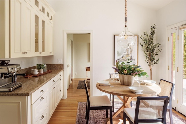dining room with light wood finished floors and baseboards