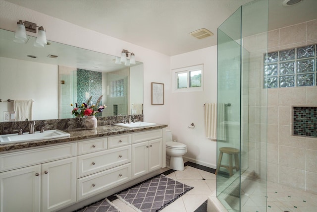 bathroom featuring radiator, a sink, a stall shower, and tile patterned flooring