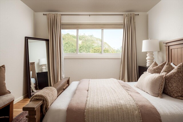 bedroom featuring baseboards and light wood-style floors