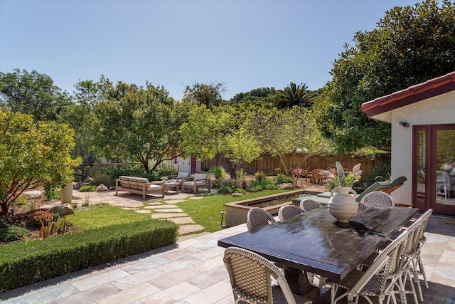 view of patio / terrace with outdoor lounge area, outdoor dining space, and fence